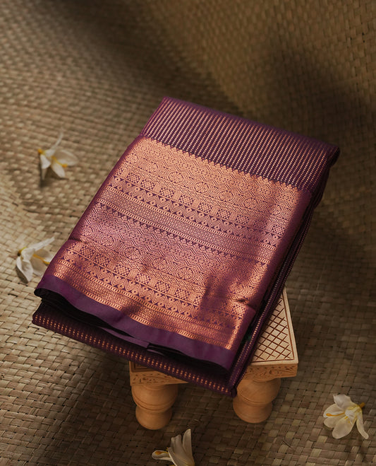 Dark Purple colour Semi Silk Saree with copper zari stripes on the body, paired with a contrast Khaki green colour pallu with copper zari traditioal border, and a matching blouse piece.