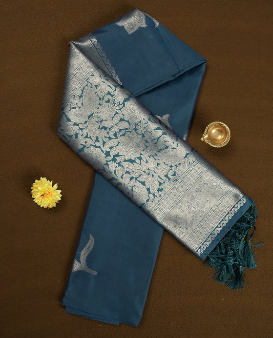 Teal Blue Semi Silk Saree with Silver Zari Floral Woven Pallu and Border, Subtle Zari Butta Motifs on the Body, Tassel Detailing, and Coordinated Blouse Piece