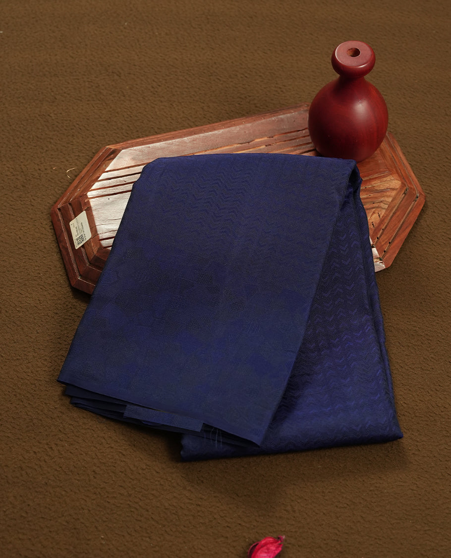 Dark blue colour semi soft silk saree featuring a self coloured textured patterned body, complemented by self coloured tiny diamond motifes on pallu & border and a matching blouse piece.