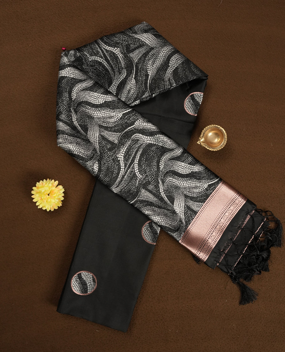 Black colour semi silk saree featuring elegant circular motifs on the body, complemented by white wavy designed pallu with striking border adorned with intricate golden thread patterns,and paired with a matching blouse