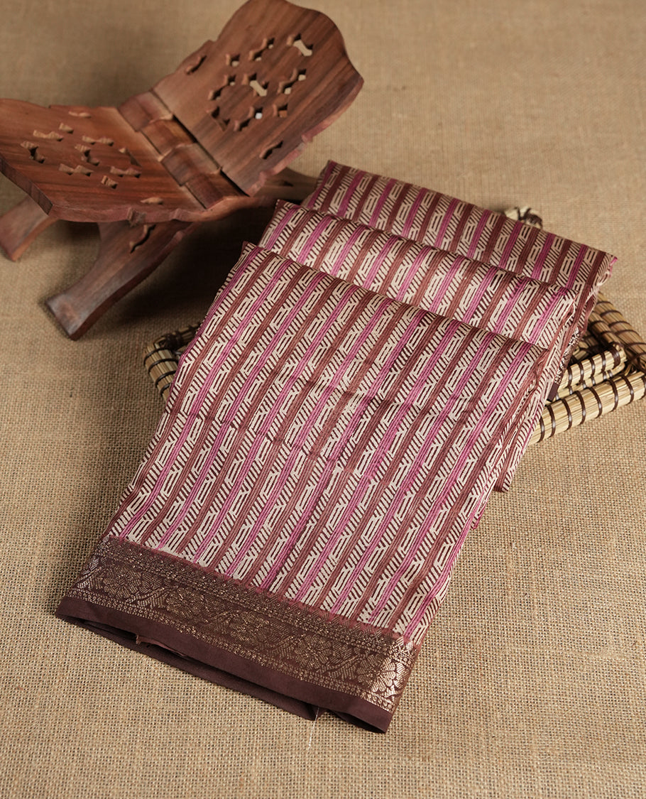 Cream colour chanderi silk saree with Brown& pink geometric stripped printed On body, compilmented by contrast chocolate brown colour border with golden zari floral pattern and a matching blouse.