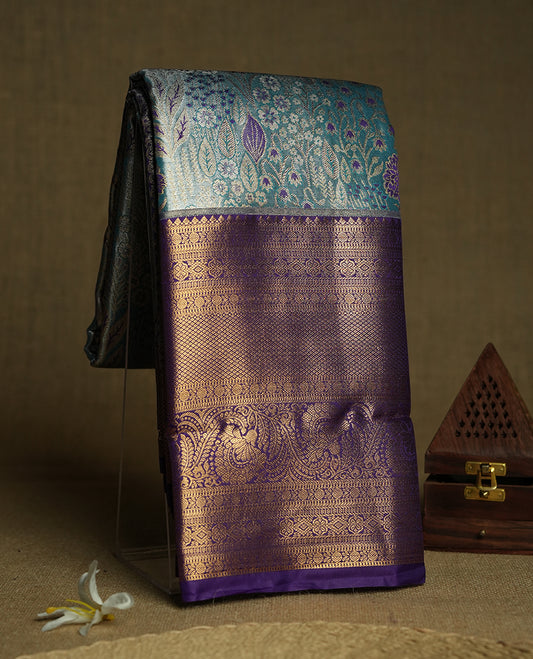 Sky blue colour and Antique gold Zari Tissue Brocade Saree features intricate coloured floral Motifs on body and a blue colour with traditional border & pallu, paired with matching blouse