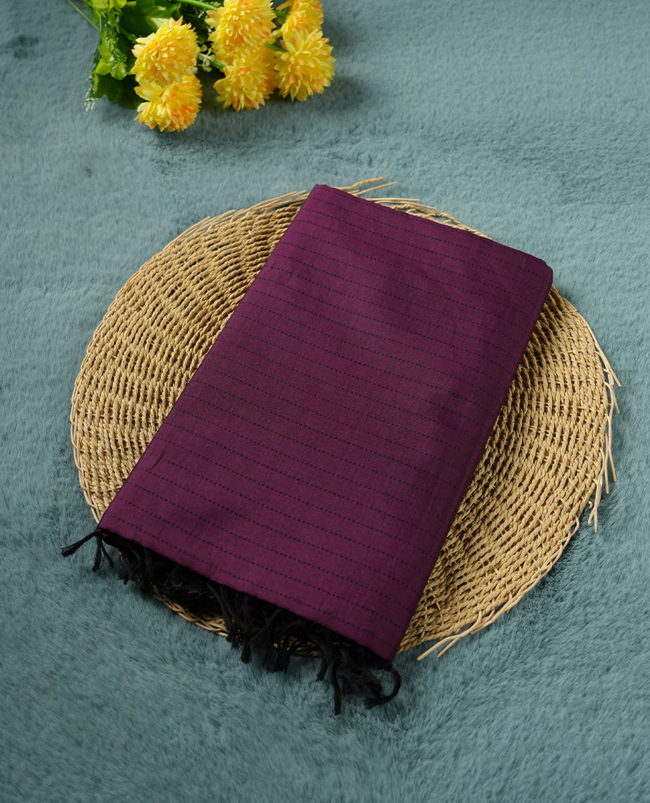 Purple colour poly cotton saree with black vertical dotted line pattern on the body, paired with a matching pallu featuring black zigzag geometric border, and a coordinated all‑over black stylised fleur‑de‑lis printed blouse piece.