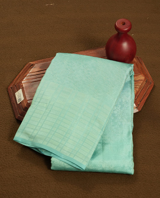 Pastel aqua blue colour semi soft silk saree featuring a self coloured textured patterned body, complemented by self coloured box motifes on pallu & border and a matching blouse piece.