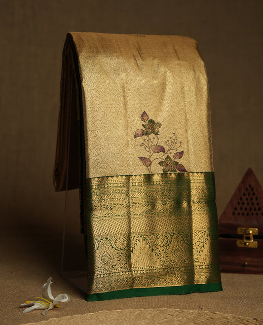 Golden colour Tissue Brocade Saree features intricate a green colour flower Motifs on body and a green colour traditional border & pallu with patterns, paired with matching blouse