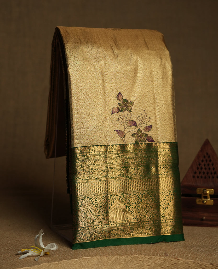 Golden colour Tissue Brocade Saree features intricate a green colour flower Motifs on body and a green colour traditional border & pallu with patterns, paired with matching blouse
