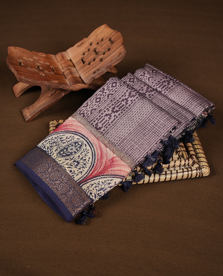 Purple colour chanderi silk saree featuring geometric print pattern across body, with contrast Blue colour border with zari pattern and paired with matching blouse.