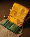 Mustard Colour Pure Banaras soft Silk Saree having gold floral motifs on Body with contrast green colour gold Floral kodi pattern on Border and matching Blouse