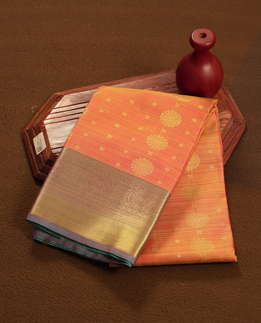 Gold and Orange colour semi soft silk saree featuring a golden patterned body, complemented by contrast green colour with gold traditional pallu & border and a matching blouse piece.