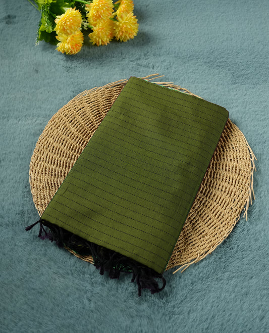 Green colour poly cotton saree with black vertical dotted line pattern on the body, paired with a matching pallu featuring black zigzag geometric border, and a coordinated all‑over black stylised fleur‑de‑lis printed blouse piece.