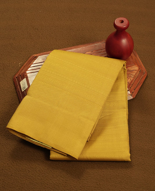 Maple colour semi soft silk saree featuring a self coloured textured patterned body, complemented by self coloured motifes on pallu & border and a matching blouse piece.