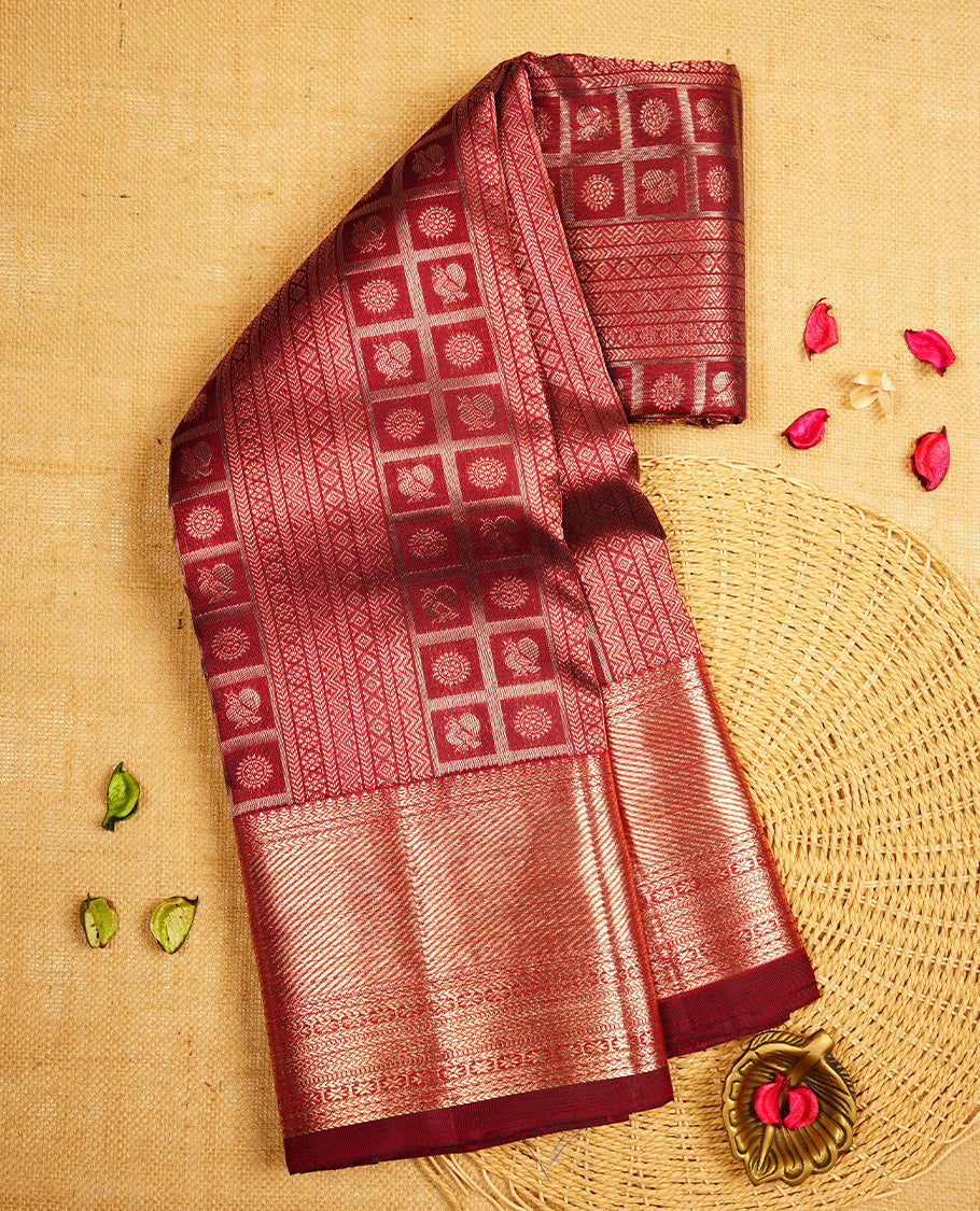 Dark maroon colour Kanchipuram Samudrika Silk Saree featuring poo chakram & bird in square pattern weaving with gold zari jacquard and a traditional zari border, paired with a matching designer jacquard blouse piece