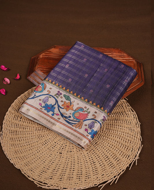 Violet colour semi tusser silk saree featuring gold zari check pattern with floral butti motifs, with contrast floral kodi & bird pattern and paired with matching blouse.