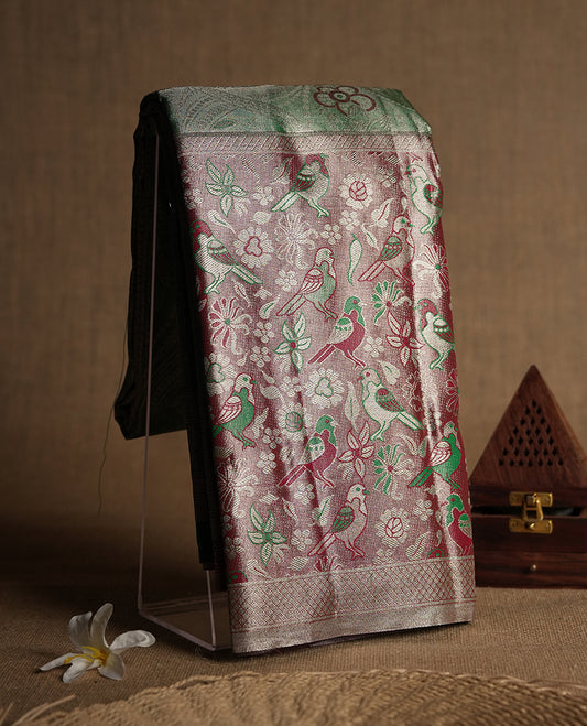 Bright green colour and Antique silver Zari Tissue Brocade Saree features intricate red coloured floral Motifs on body and fancy border & pallu with bird patterns, paired with matching blouse