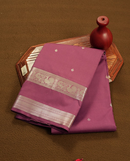 twilight lavender colour semi soft silk saree featuring a gold colour textured patterned body, complemented by self coloured golden motifes on pallu & border and a matching blouse piece.