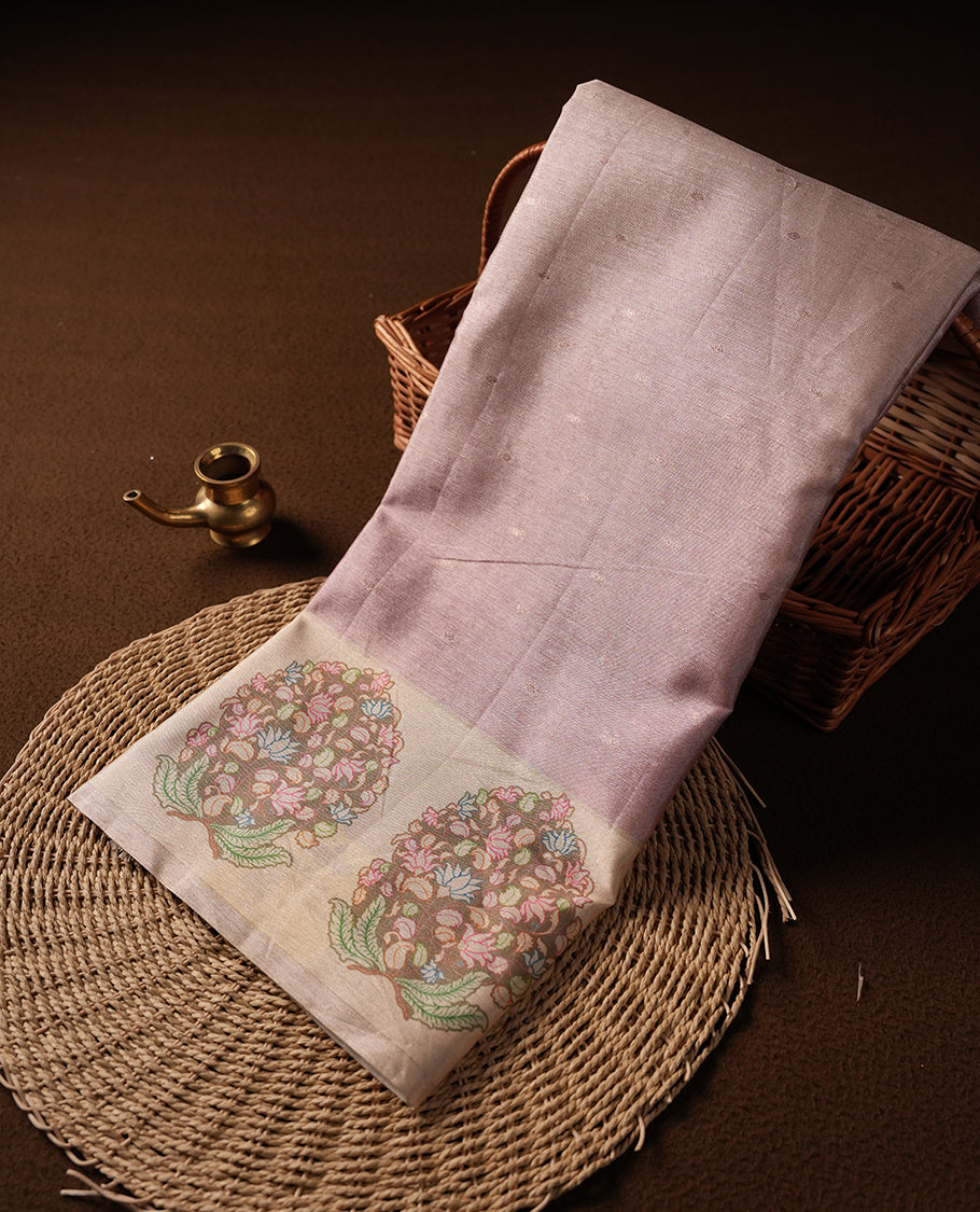 Rose gold colour semi tussar saree adorned with gold zari motifs across the body and Floral pattern contrast cream colour on border, paired with a matching blouse.