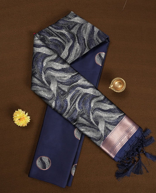 Dark blue semi silk saree featuring elegant circular motifs on the body, complemented by a striking pallu adorned with intricate wavy white thread patterns with golden border, and paired with a matching blouse