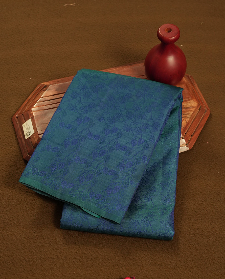 Peacock blue colour semi soft silk saree featuring a self coloured textured patterned body, complemented by self coloured tiny diamond motifes on pallu & border and a matching blouse piece.