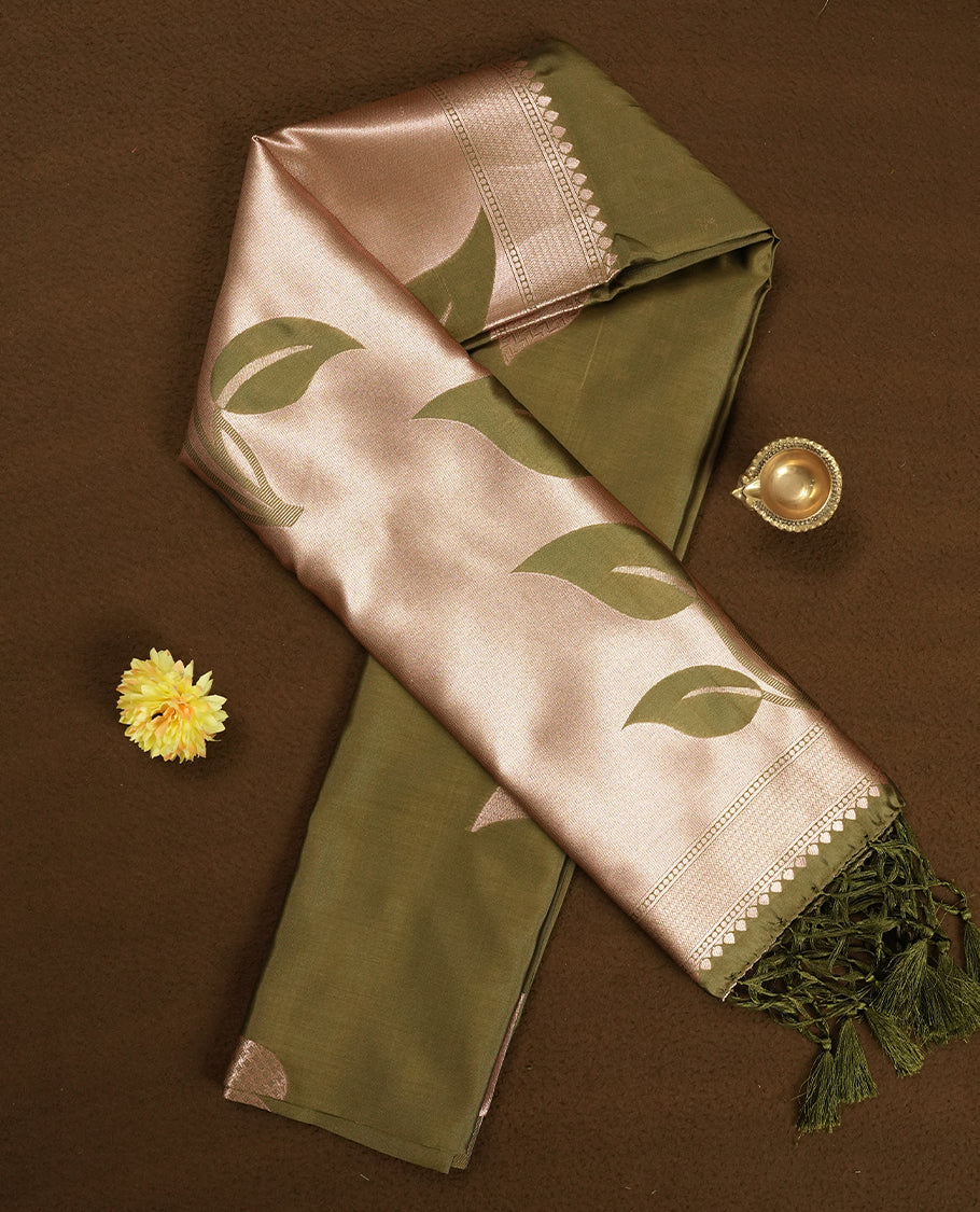Olive Green colour Semi Silk Saree with Rose Gold Satin-Finish Pallu Featuring Bold Leaf Motifs, Geometric Zari Edging and Tassels, Paired with Coordinated Blouse Piece