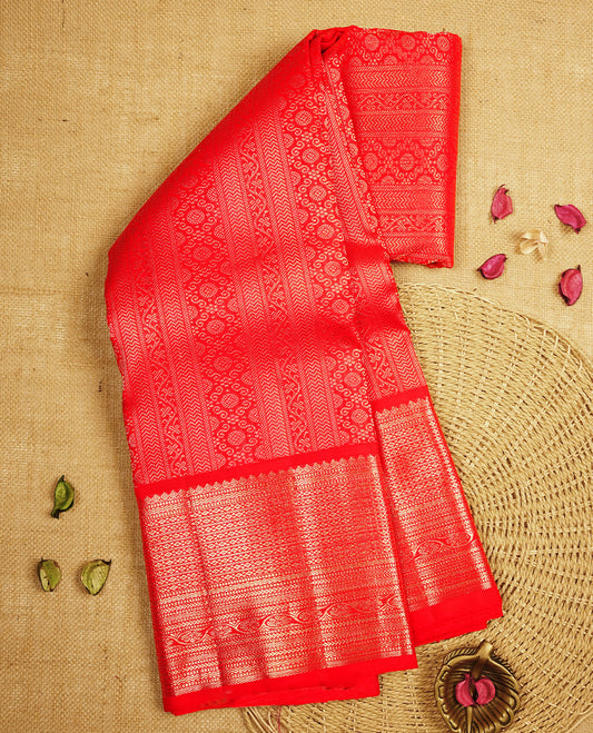 Bright red colour Kanchipuram Samudrika Silk Saree featuring Floral kodi  strip pattern weaving with gold zari jacquard and a traditional zari border, paired with a matching designer jacquard blouse piece