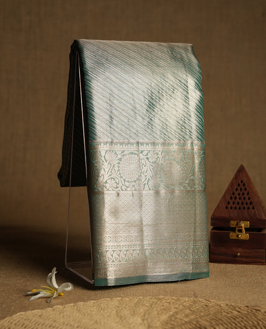 Green colour and Antique gold Zari Tissue Brocade Saree features intricate line Motifs on body and traditional border & pallu , paired with matching blouse