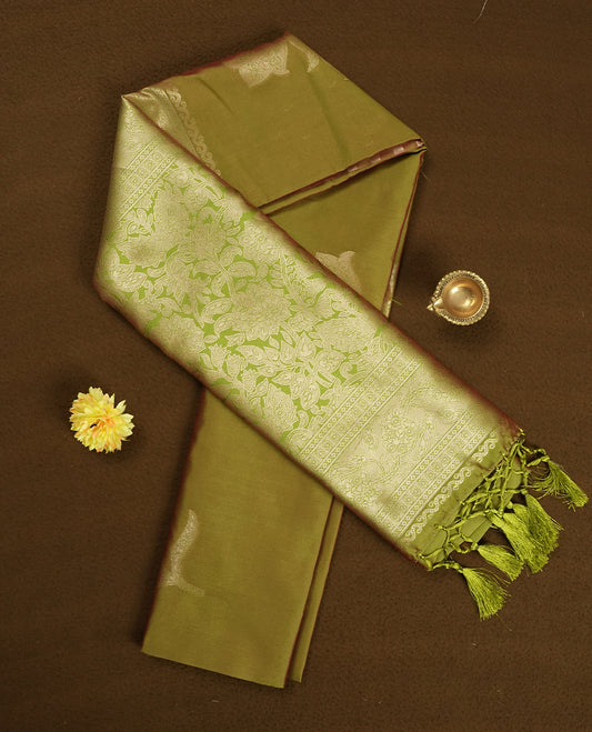 Olive Green colour semi silk saree adorned with floral motifs on the body, complemented by a shimmering golden zari-woven pallu and border, and paired with a matching blouse