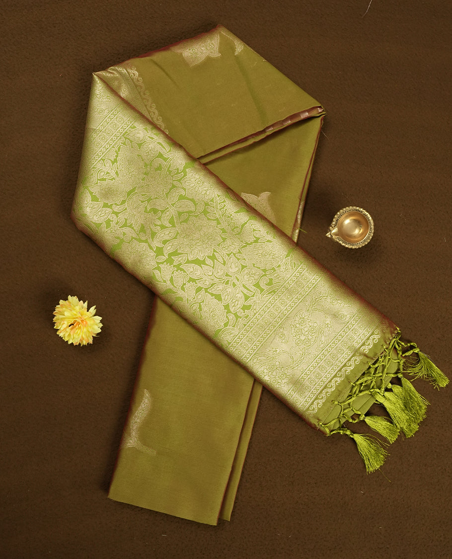Olive Green colour semi silk saree adorned with floral motifs on the body, complemented by a shimmering golden zari-woven pallu and border, and paired with a matching blouse