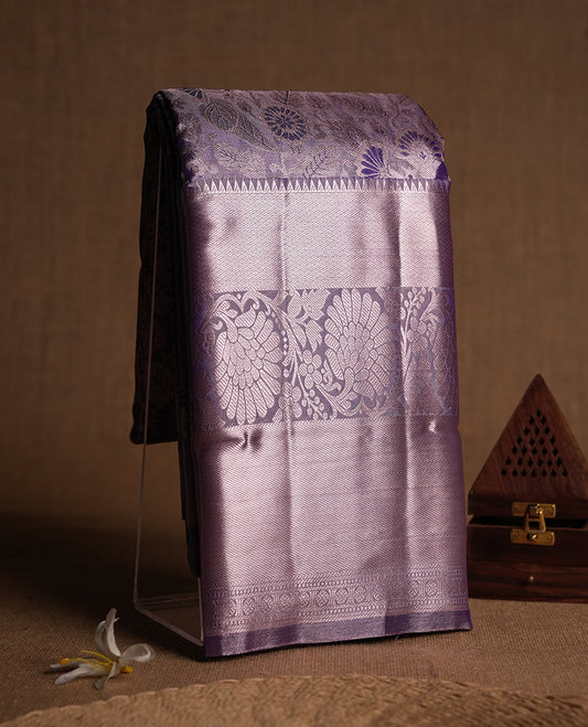 Lavender colour and Antique silver Zari Tissue Brocade Saree features intricate a navy blue coloured floral Motifs on body and A rose gold traditional border & pallu with floral patterns, paired with matching blouse