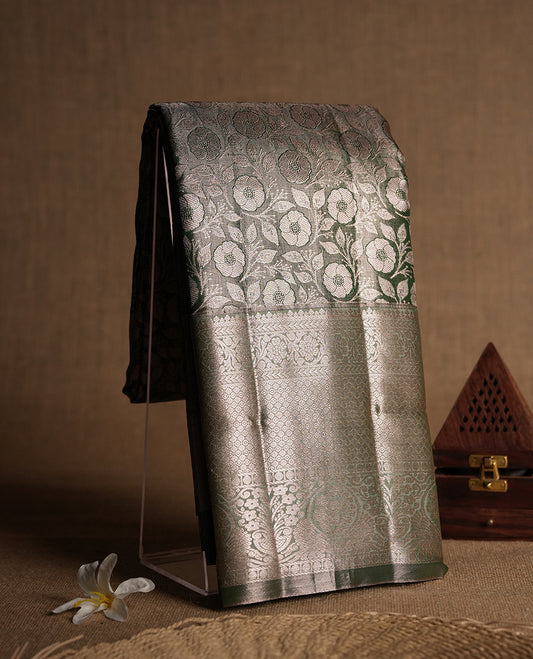 Dull green colour and Antique gold Zari Tissue Brocade Saree features intricate floral Motifs on body and fancy border & pallu with floral patterns, paired with matching blouse