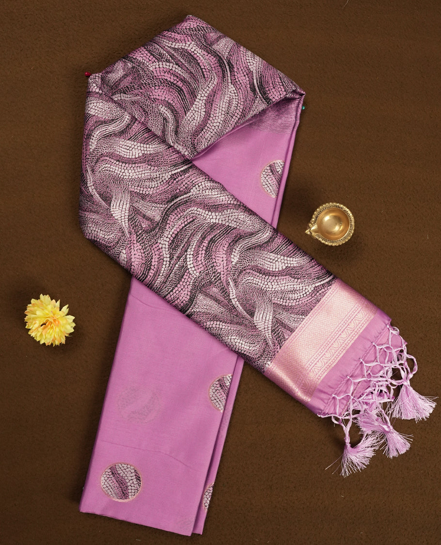 pink semi silk saree featuring elegant circular motifs on the body, complemented by a striking pallu adorned with intricate wavy white thread patterns with golden border, and paired with a matching blouse