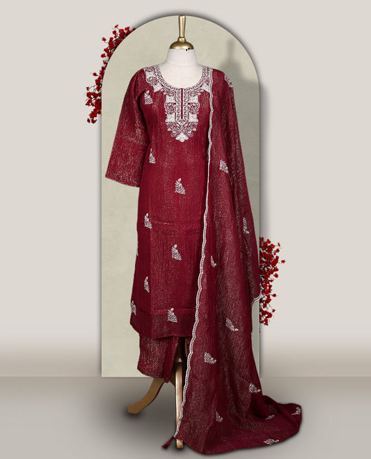 Maroon churidar set featuring elegant white thread embroidery on the neckline, sleeves, and scattered motifs across the body, Paired with a matching embroidered dupatta, this ensemble radiates graceful charm and festive appeal.