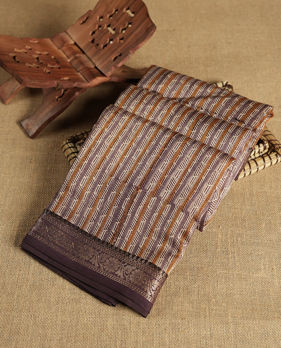 Cream colour chanderi silk saree with purple & yellow geometric stripped printed On body, compilmented by contrast Dark purple colour border with golden zari floral pattern and a matching blouse.