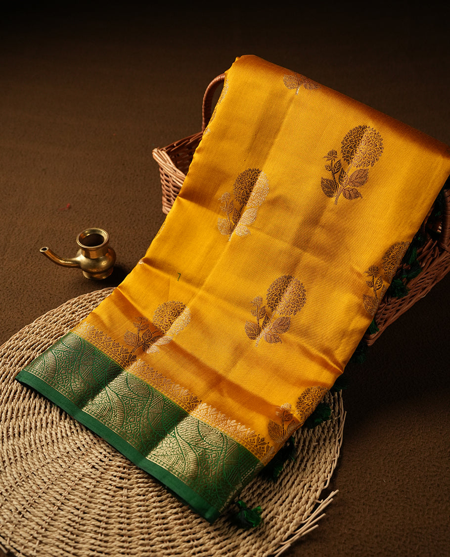 Mustard Colour Pure Banaras soft Silk Saree having gold floral motifs on Body with contrast green colour gold zari Border and matching Blouse