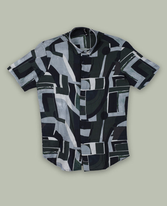 Dark green colour shirt featuring bold abstract geometric prints in shades of black, white, and grey & Designed with a classic collar and short sleeves, it offers a trendy, artistic look perfect for casual outings.