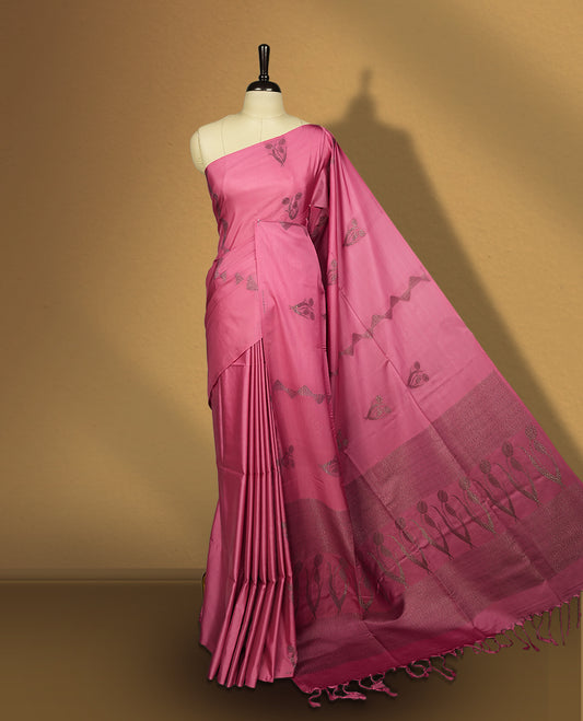 Soft pink colour semi soft silk saree, adorned with subtle woven floral motifs on the body & The design is elevated with an elegant zari border and pallu with tassels, paired with a matching blouse.