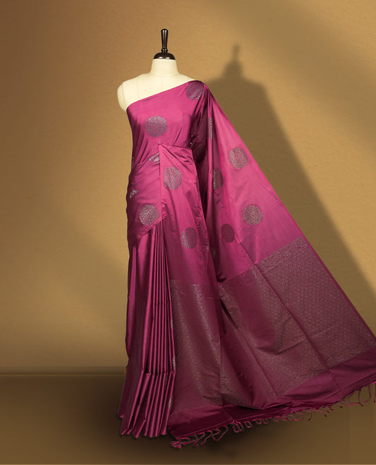 Soft Maroon colour semi soft silk saree adorned with woven circular motifs on the body, complemented by a rich contrast woven pallu with tassel detailing & Comes with a matching blouse piece.
