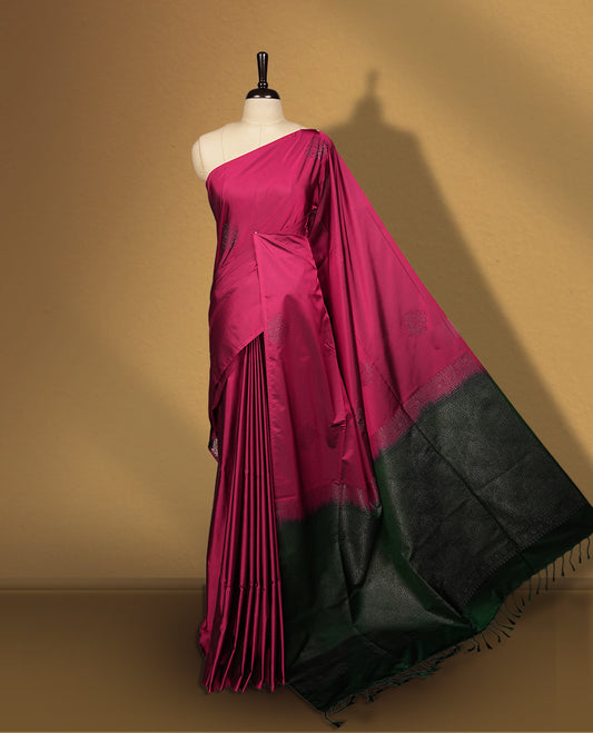 Burgundy colour semi soft silk saree, beautifully designed with woven leaf motifs & The look is enhanced by a rich contrast green pallu, paired with a matching blouse.