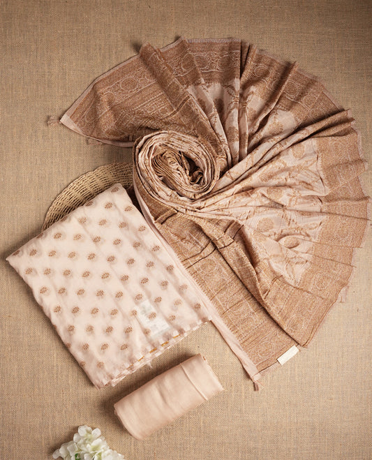 Elegant beige colour suit material adorned with subtle golden designs, exuding timeless charm & Paired with a beautifully woven dupatta and a matching plain bottom.
