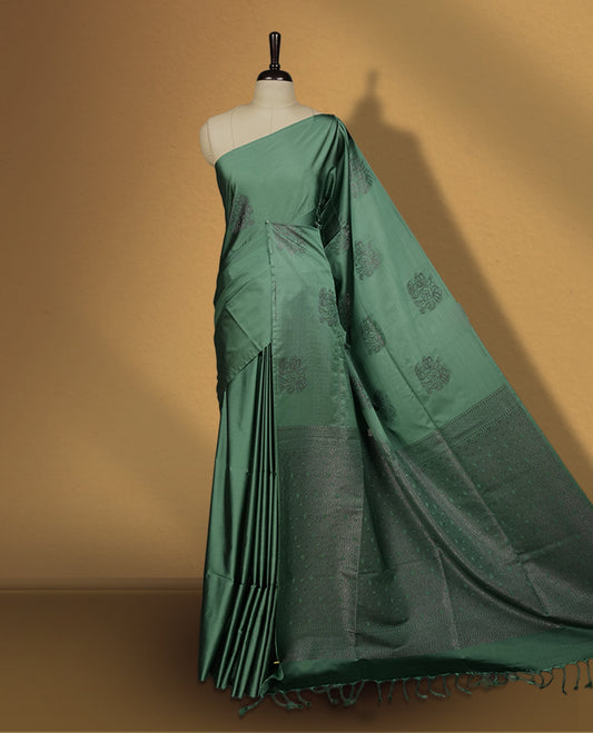 Soft aqua green colour semi soft silk saree featuring self woven motifs on the body, elegant woven border, and rich matching pallu with tassel finish & Comes with a coordinating blouse piece for a graceful look.