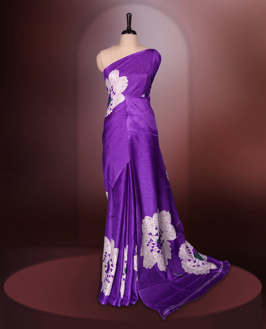 Purple colour saree highlighted with bold white floral prints, blending contemporary style with ethnic grace and paired with a matching blouse.