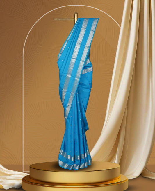 Sky blue colour soft silk saree with delicate silver zari buttas, complemented by a shimmering silver border and pallu & Paired with a matching blouse.