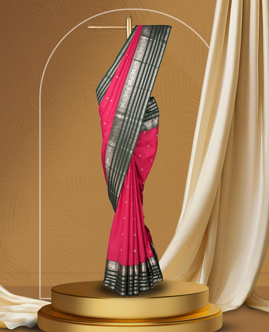 Pink and green colour soft silk saree with rich silver zari border and buttas, paired with a matching blouse.