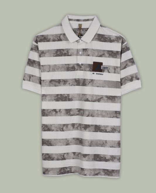 Off white and grey colour striped polo T shirt featuring a collared neck with button placket, half sleeves, and a textured fabric design, enhanced with a front chest patch that adds a trendy casual vibe.