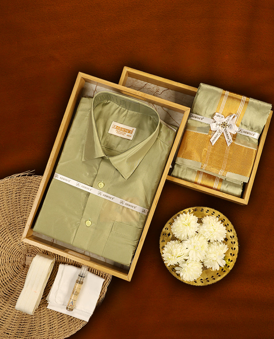Fir green colour Aswin’s wedding set featuring a premium silk shirt, matching dhoti with rich golden zari border, complemented by a towel and fragrance, crafted for graceful festive celebrations.