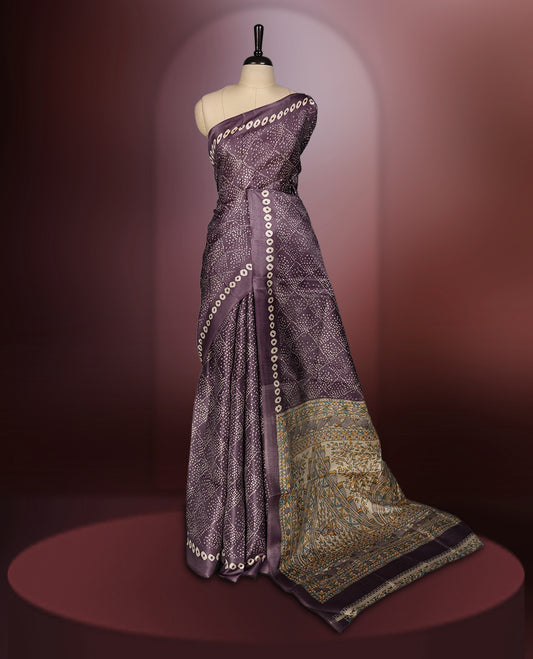 Light Wine colour saree adorned with intricate beige bandhani patterns and a contrasting pallu featuring exquisite beige floral motifs, perfectly paired with a matching blouse for a regal look.