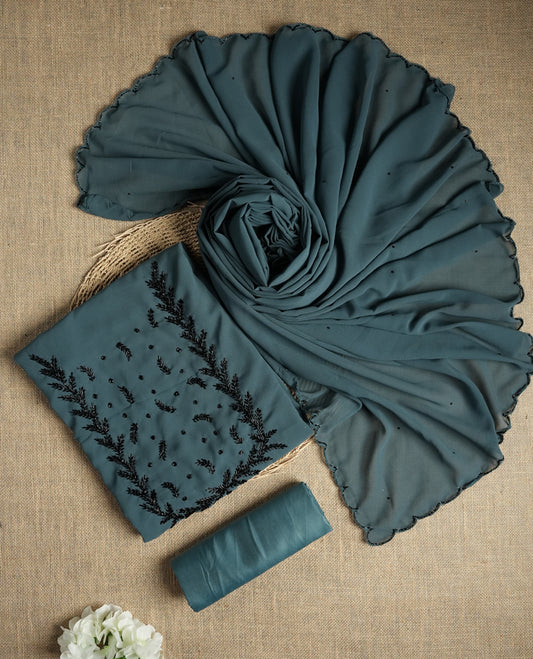 Elegant grey colour suit material adorned with intricate black cut beads work, exuding sophisticated charm & paired with a soft dupatta and a matching plain bottom.