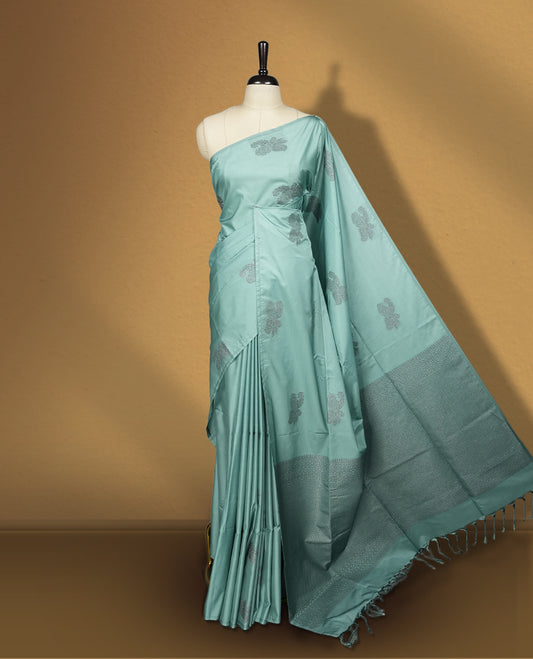 Pastel blue colour semi soft silk saree, adorned with subtle woven floral motifs on the body & The design is elevated with an elegant zari border and pallu, paired with a matching blouse.