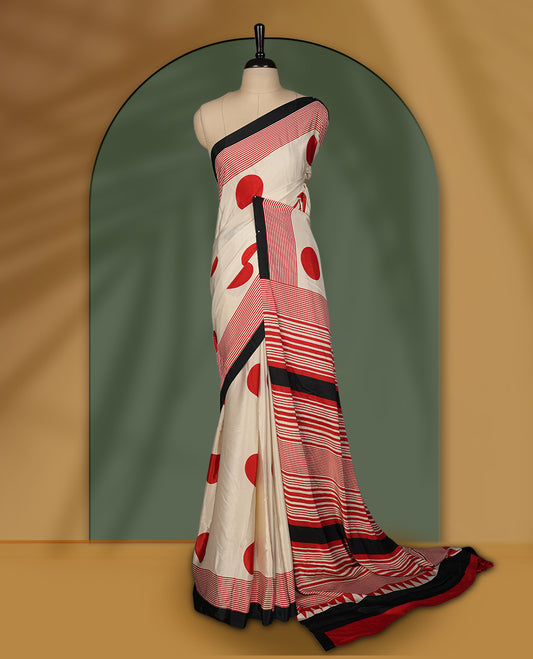 Ivory colour saree with bold red polka dots and contrasting black red striped pallu & Comes with a stylish matching blouse.