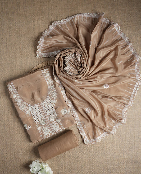 Beige colour suit material adorned with elegant white thread , cut beads & sequin embroidery, highlighted by a delicate lace border & Paired with a matching embroidered dupatta and plain bottom.