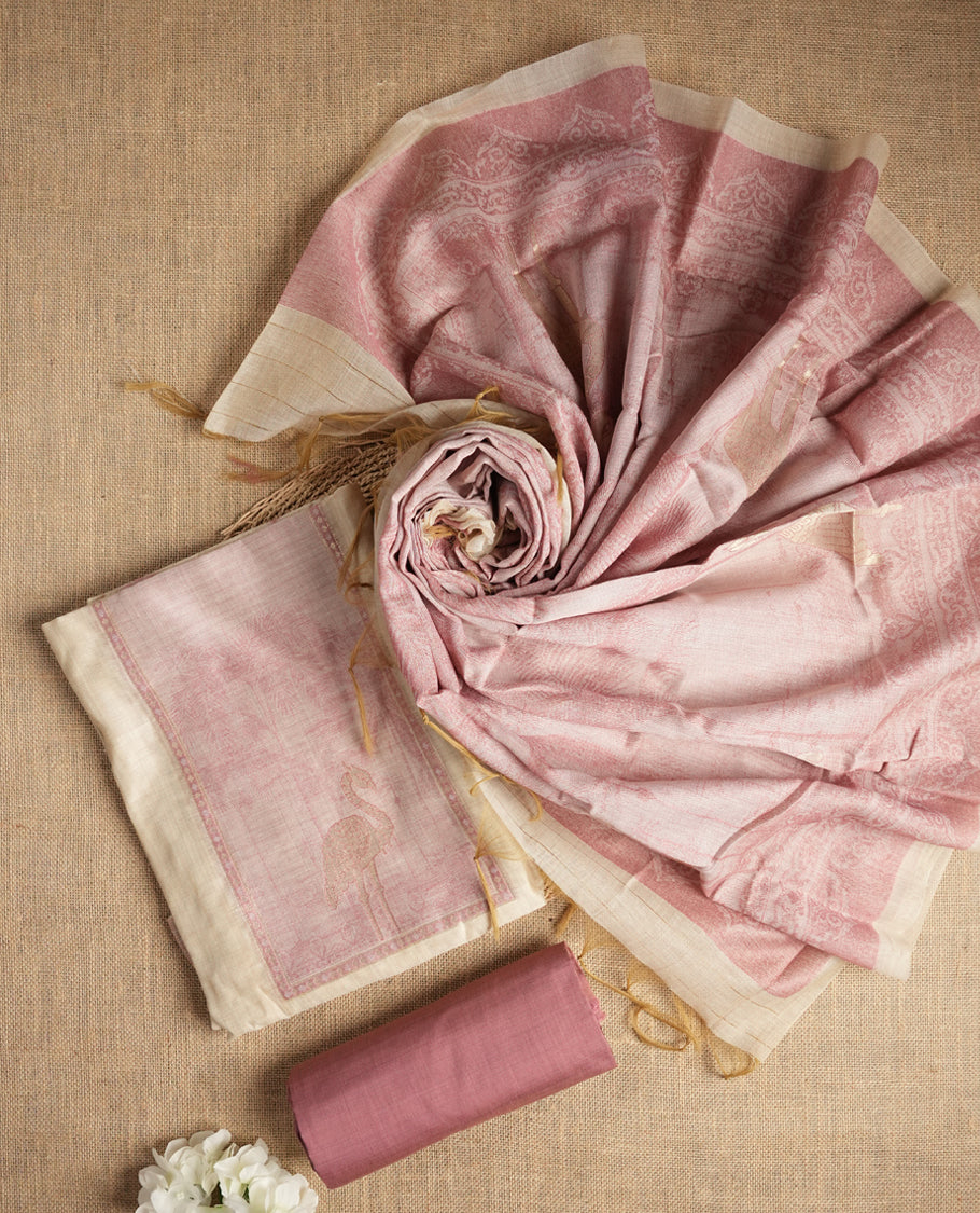 Beige & Onion pink colour suit material adorned with intricate woven patterns, bird print & subtle motifs, exuding ethnic grace & paired with a beautifully bordered dupatta and a matching plain bottom.